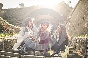 Three young girls sitting on the stairs at the public park. Three young girls sitting on the stairs at the public park an having