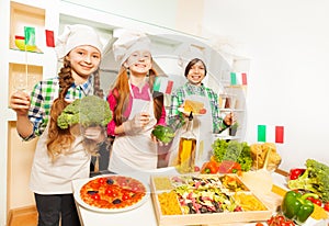 Three young Italian cooks at the kitchen