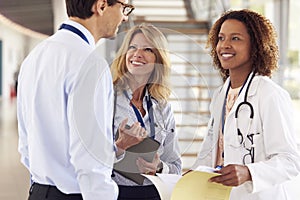 Three young male and female doctors in consultation