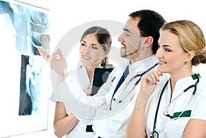 Three young medical workers looking at the x-rays