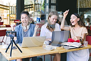 Three young millennials girls working together