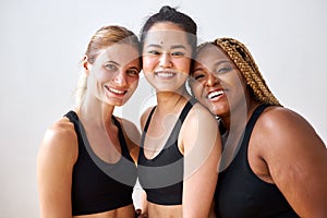 Three young multi ethnic female models of different race, hair colour and body size posing at camera