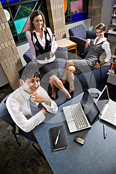 Three young office workers working in meeting room