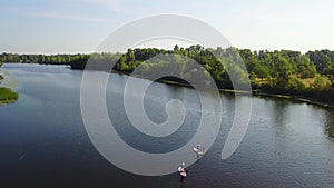 Three young people are kayaking on the river