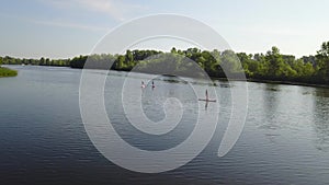 Three young people are kayaking on the river