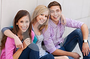 Three young people smiling