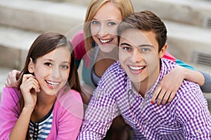 Three young people smiling