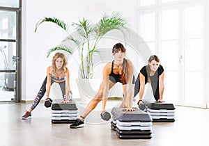 Three young people working out in a fitness class