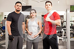 Three young people working out at the gym