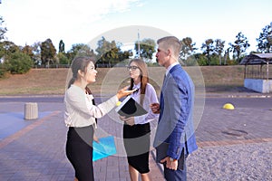 Three young successful businessman, students communicate, smilin