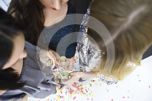 Three young woman having fun with champagne