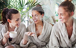 Three young women drinking tea at spa resort