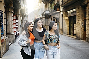 Women hanging out on a comercial street photo