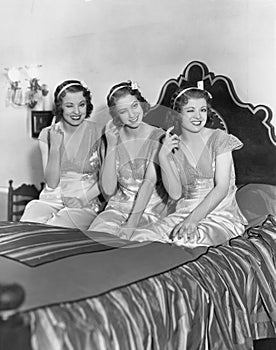 Three young women winking