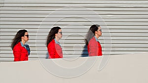 Threefold girl walks between a wall and sheet photo