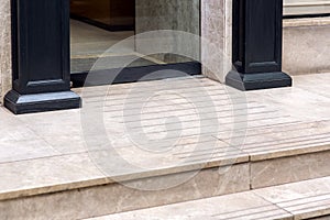 A threshold with a step from a marble tile an entrance to shop.