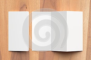 Thrifold - Three fold brochure mock up on wooden background. 3d