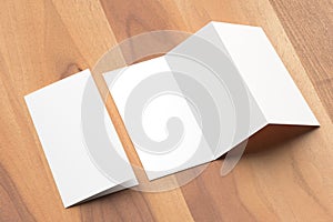 Thrifold - Three fold brochure mock up on wooden background. 3d