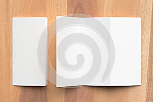 Thrifold - Three fold brochure mock up on wooden background. 3d