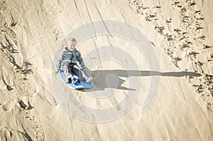 Thrill seeking boy Playing in the Sand Dunes Outdoor Lifestyle photo