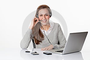 Thrilled 20s professional with headset and computer in white office
