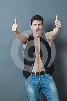 Thrilled 20s sportsman with bare chest and thumbs up shouting