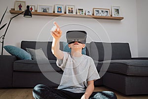 Boy experiencing virtual world by using virtual reality headset