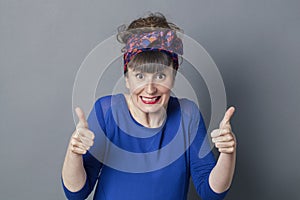 Thrilled retro 30s woman with thumbs up for exciting success
