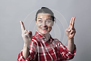 Thrilled woman showing both hands like fun guns for power photo