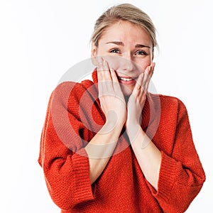 Thrilled woman touching her face for wellbeing and pleasure