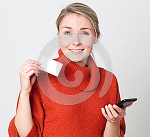 Thrilled young blond woman making a shopping transaction online