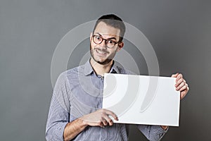Thrilled young businessman holding banner for copy space text photo