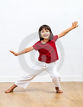 Thrilled young girl dancing, showing her smile expressing positive emotions photo