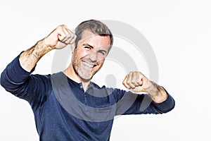 Thrilled young man showing happiness, success with optimism and energy