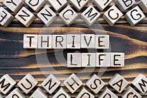thrive life - phrase from wooden blocks with letters
