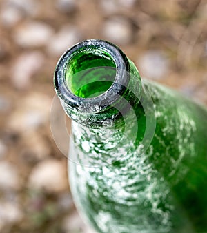 Throat old green bottle in nature