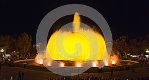 Throngs of people at the colourful light & water fountain show. Night in Barcelona, Spain, at the magic fountain.