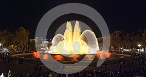 Throngs of people at the colourful light & water fountain show. Night in Barcelona, Spain, at the magic fountain.