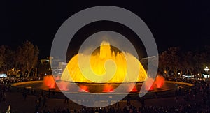 Throngs of people at the colourful light & water fountain show. Night in Barcelona, Spain, at the magic fountain.