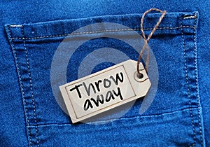 Throw away tag on blue jean background.