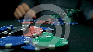 Throw the blue chips in poker. Blue and Red Playing Poker Chips in Reflective black Background. Closeup of poker chips