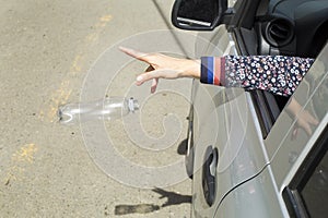 Throw plastic bottle from the car