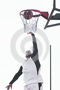 Throwing basketball ball in basket