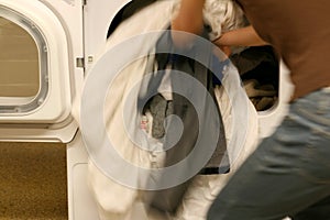 Throwing clothes into dryer