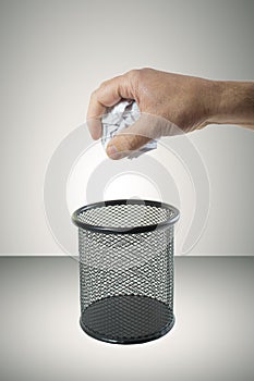 Throwing crumpled paper in the trash