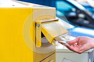 Throwing a letter in a yellow mailbox