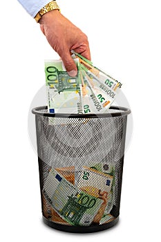 Throwing money away into the trash