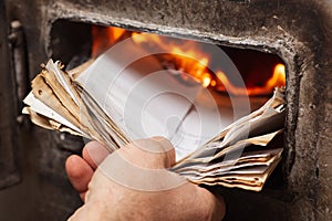 Throwing old papers into the heating boiler