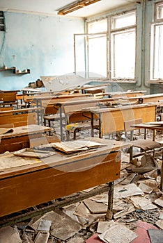 The thrown and destroyed school in Pripyat after the Chernobyl accident in Ukraine in 1986. School desks and scattered textbooks