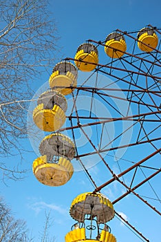 The thrown wheel a review against the blue sky in amusement park in Pripyat after the Chernobyl accent in